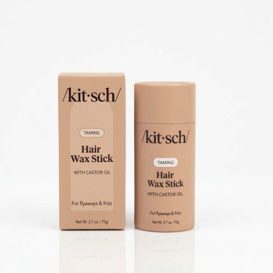 Kit Sch Hair Wax Stick in the shade 'Taming' shown next to its cardboard packaging box on a clean white reflective surface.